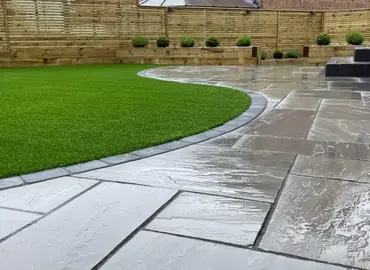 Promenade Classicstone sandstone patio in cool gray tones, offering a modern large format design for stylish outdoor living.