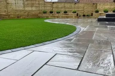 Promenade Classicstone sandstone patio in cool gray tones, offering a modern large format design for stylish outdoor living.